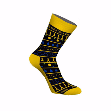 Black and yellow socks with retro illustrations and Catan written in yellow at the top part