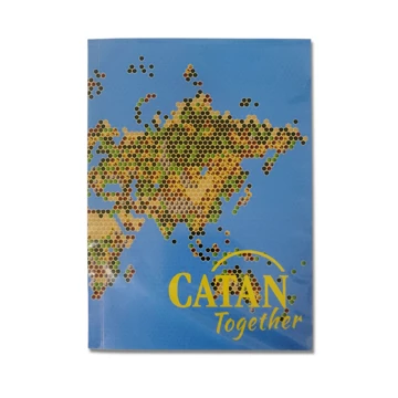 Image of a blue notebook with a map and CATAN logo on the cover