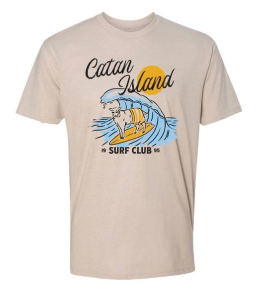 Catan Island Surf Tee Front Image. An illustration of a sheep surfing, written "Catan Island Surf Club" under it