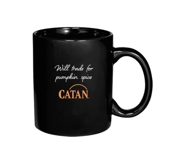 Black mug with an prange Catan symboll, written "Will trade for pumpkin spice" in white in the middle
