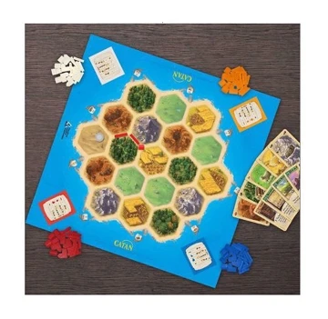 Board of the game Catan Play Board flat on the ground, surrounded by the game's cards and pieces