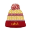 A red beanie with a yellow, blue, and white snowflake pattern and a red and white pompom. The beanie has the "Catan" logo on the bottom cuff.