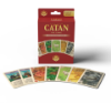 "Catan: The Game Replacement Cards" box displayed upright with several cards fanned out in front of it. The visible cards include resource cards (brick, wood, sheep, wheat, ore) and development cards like “Knight.” The setup highlights the artwork and design consistency of the replacement deck.