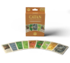 Display of the “Catan: Cities & Knights Replacement Cards” box standing upright with a spread of cards in front of it. The cards include a mix of resource, commodity, and progress cards with detailed illustrations and vibrant colors, representing the variety included in the set.